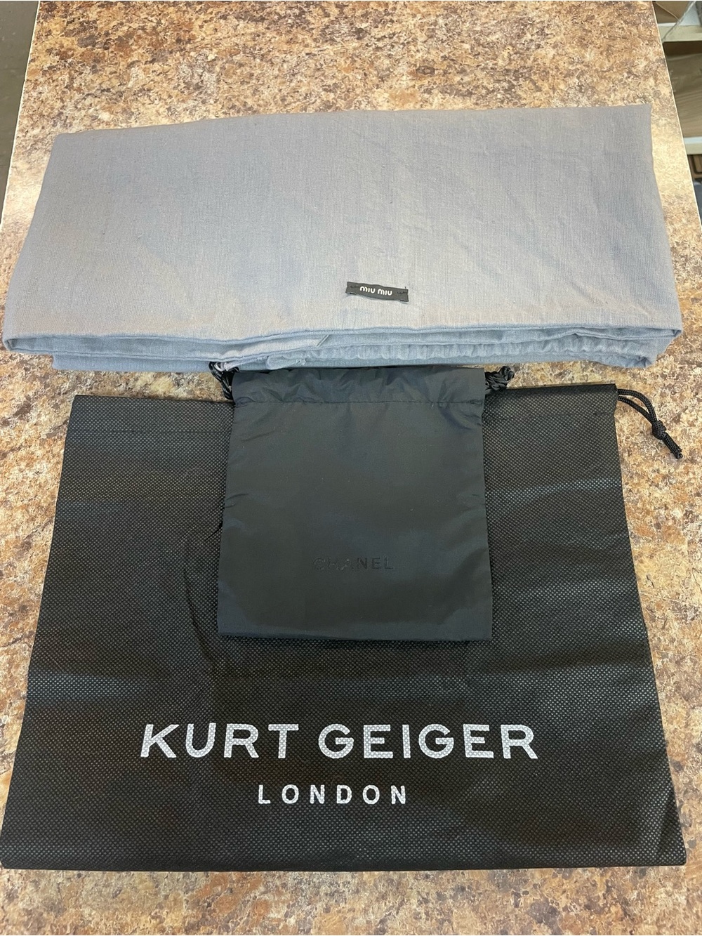 Chanel, MIU MIU and a Kurt Geiger dust bags
